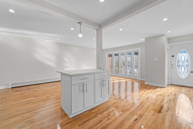 interior space with a baseboard radiator and light hardwood / wood-style flooring