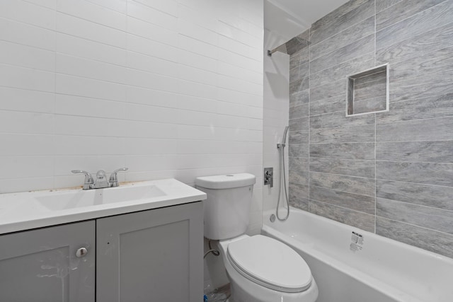 full bathroom featuring toilet, vanity, and tiled shower / bath combo