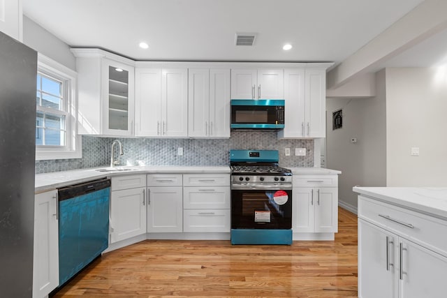 kitchen featuring light hardwood / wood-style floors, white cabinets, and appliances with stainless steel finishes