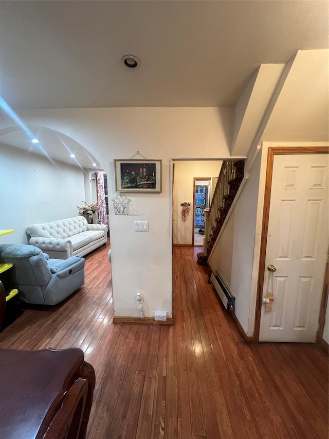 hall with a baseboard heating unit and hardwood / wood-style floors