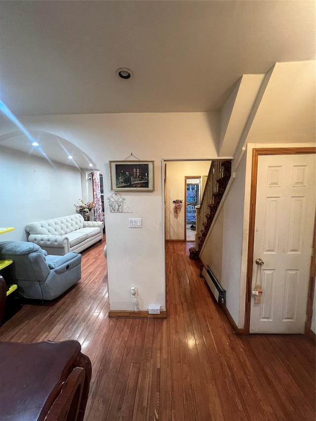 corridor featuring hardwood / wood-style floors and baseboard heating