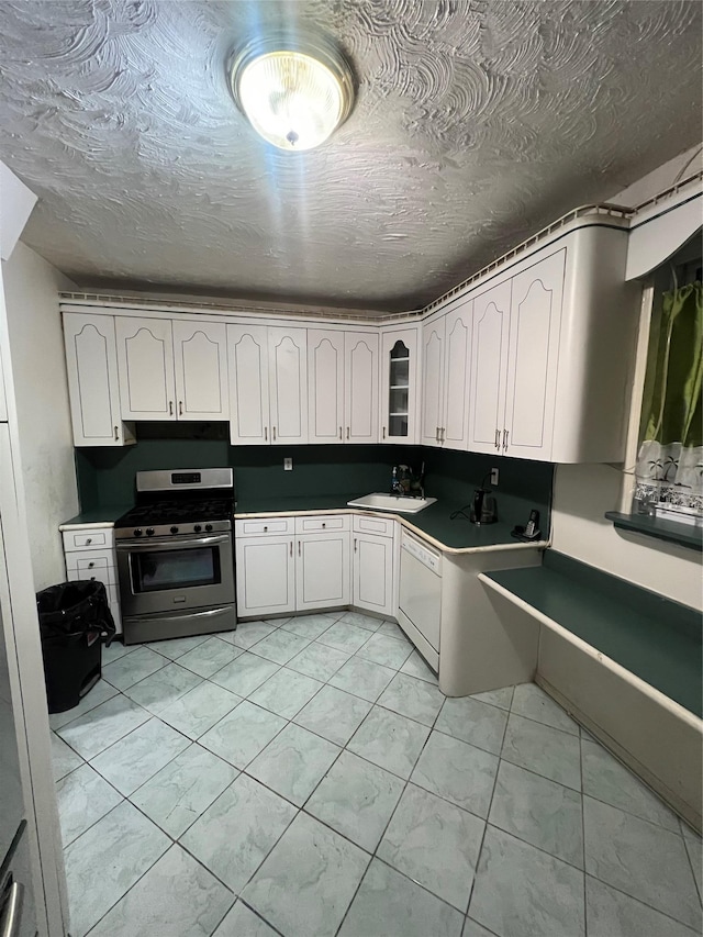 kitchen with white cabinetry, stainless steel gas range oven, dishwasher, and sink