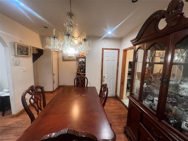 dining room featuring a notable chandelier and wood-type flooring