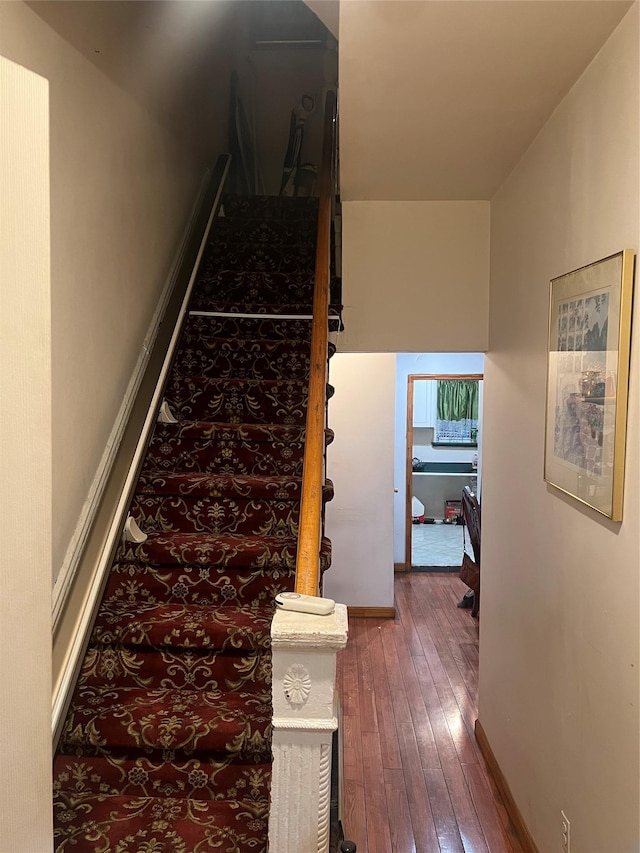 stairs with wood-type flooring