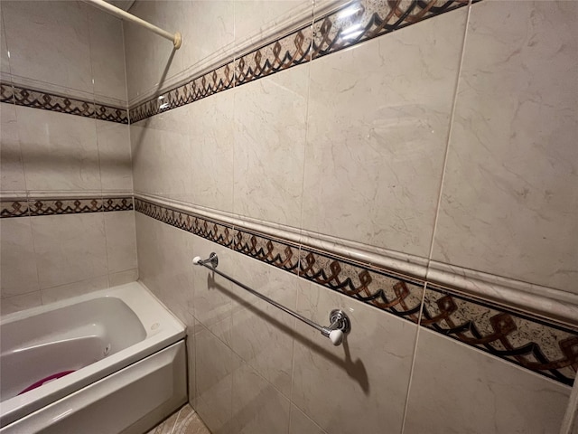 bathroom featuring tub / shower combination and tile walls