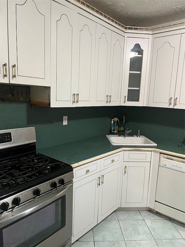 kitchen with white cabinets, white dishwasher, sink, and stainless steel gas range oven