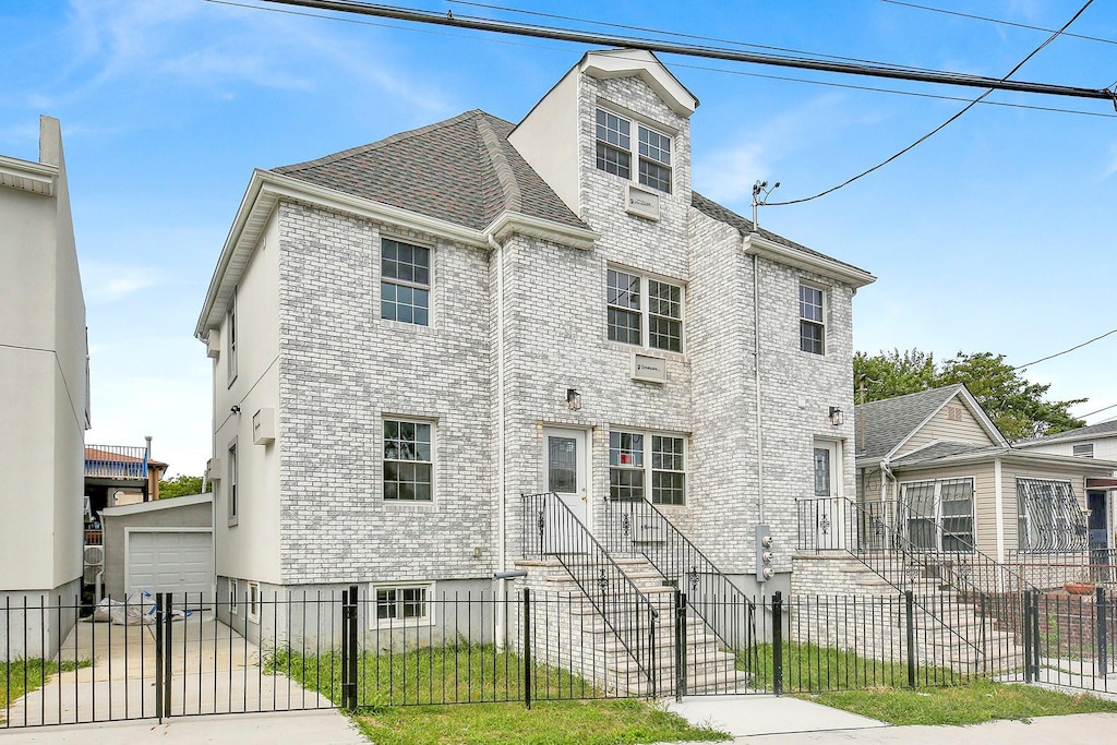 view of front facade featuring a garage and an outdoor structure