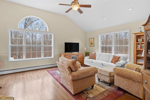 living room with ceiling fan, baseboard heating, light hardwood / wood-style flooring, and lofted ceiling