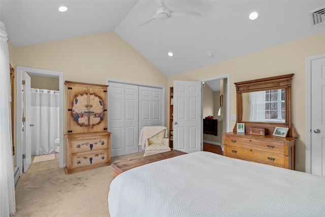 carpeted bedroom featuring ensuite bathroom, ceiling fan, vaulted ceiling, and a baseboard radiator