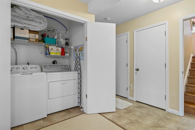 laundry room with independent washer and dryer and light tile patterned flooring