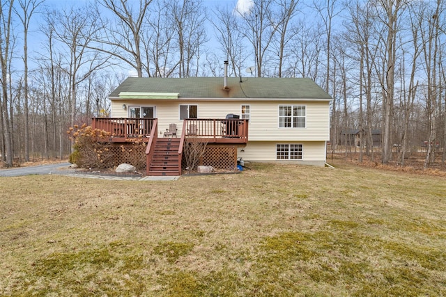 rear view of property with a deck and a yard