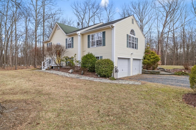 view of side of home with a yard and a garage