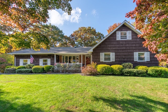 view of front of property with a front yard and covered porch