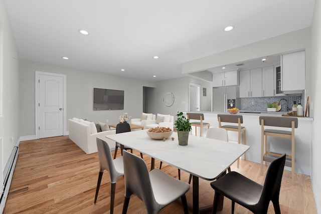 dining room featuring light hardwood / wood-style floors and a baseboard radiator