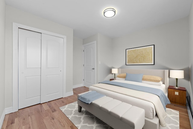 bedroom featuring light wood-type flooring and a closet