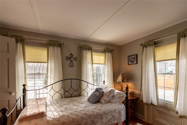 bedroom with multiple windows and ornamental molding