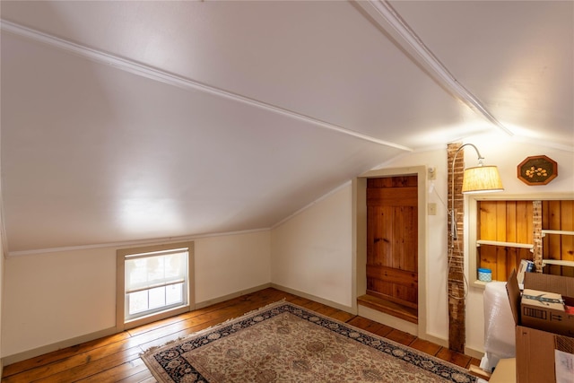 bonus room featuring vaulted ceiling and hardwood / wood-style flooring