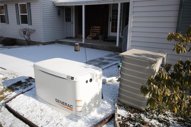 snow covered patio with central AC unit