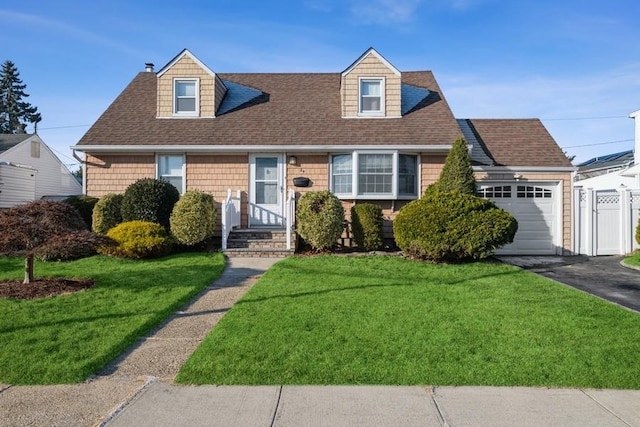 cape cod house with a front yard and a garage