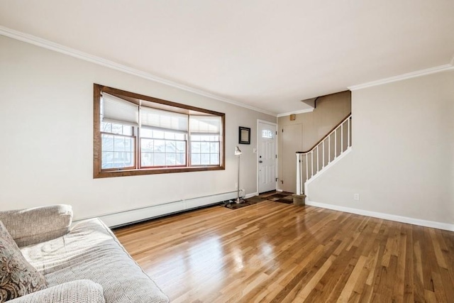 entryway with hardwood / wood-style flooring, a baseboard heating unit, and ornamental molding