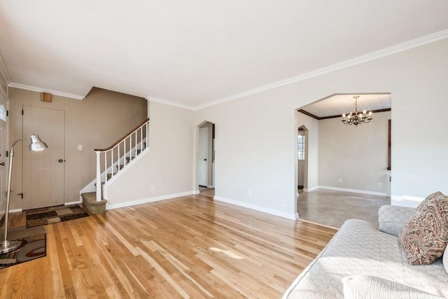 living room with ornamental molding, hardwood / wood-style flooring, and a notable chandelier