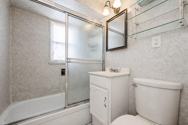 full bathroom with toilet, bath / shower combo with glass door, and vanity