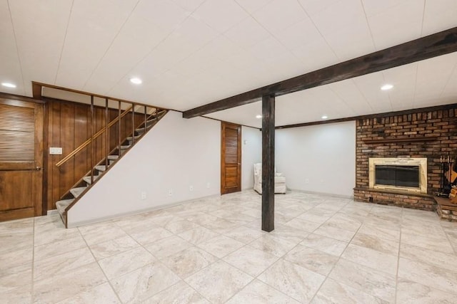 basement with wooden walls and a fireplace