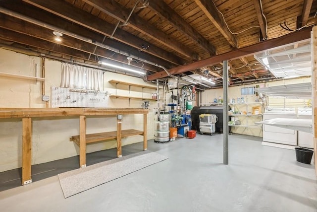 basement featuring a workshop area and washing machine and clothes dryer