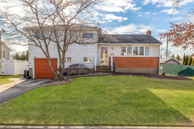 tri-level home featuring a front yard and a garage