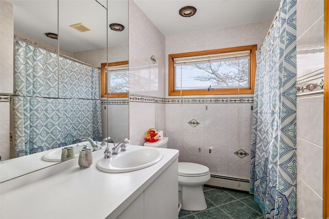 bathroom with toilet, a baseboard heating unit, tile walls, tile patterned floors, and vanity