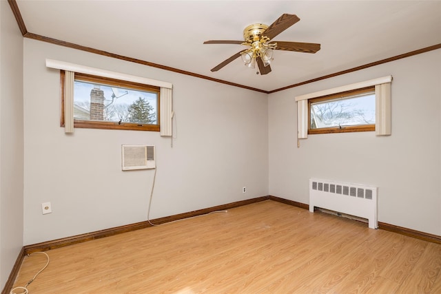 unfurnished room featuring ceiling fan, radiator, light wood-type flooring, and crown molding