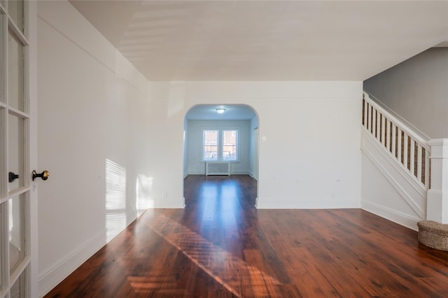 unfurnished room with dark hardwood / wood-style flooring