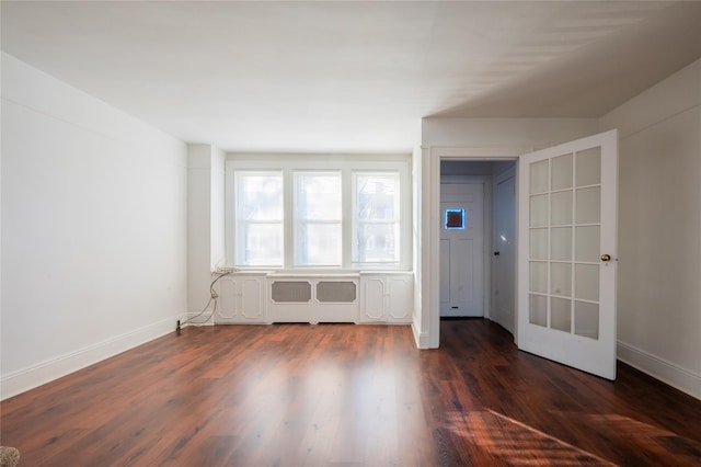 unfurnished room with dark wood-type flooring