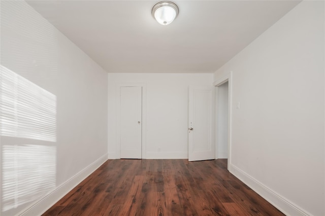 spare room featuring dark wood-type flooring