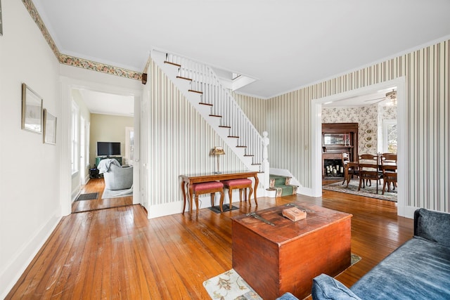 living room with ceiling fan, crown molding, and hardwood / wood-style floors