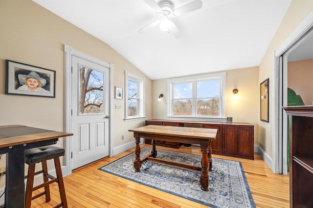 dining space featuring ceiling fan, lofted ceiling, and light hardwood / wood-style flooring