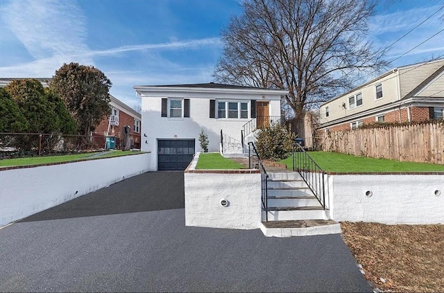 view of front of property featuring a front lawn and a garage