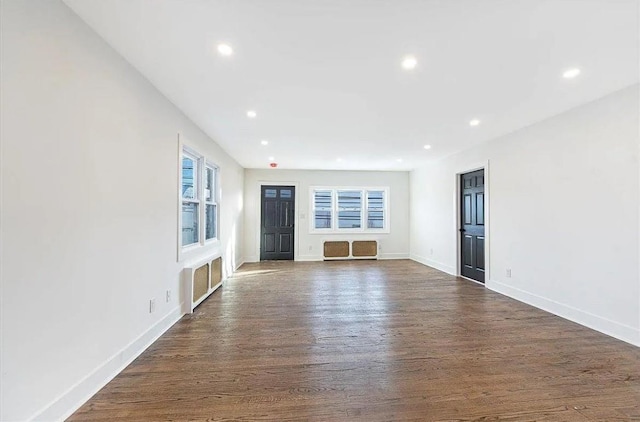 unfurnished living room with dark hardwood / wood-style floors