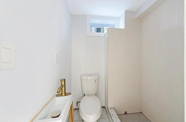 bathroom with toilet and tile patterned flooring