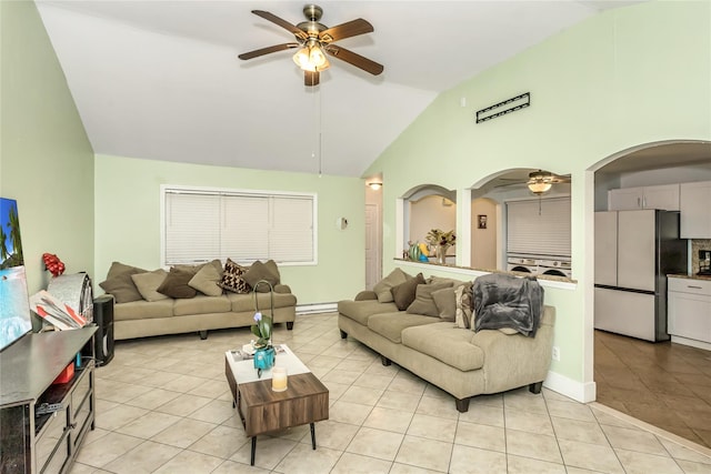 living room with vaulted ceiling, ceiling fan, and light tile patterned floors