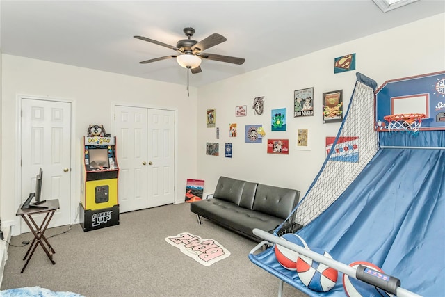 interior space with ceiling fan and carpet floors