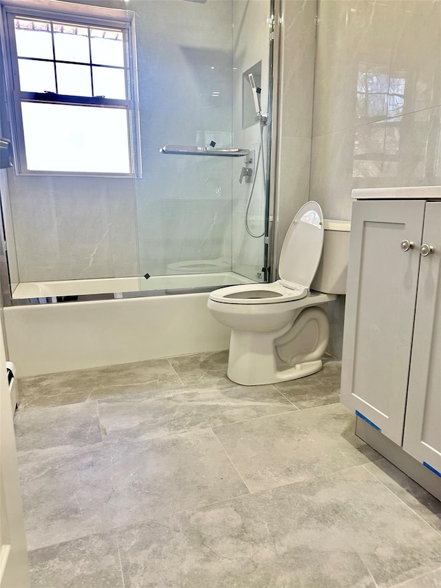 full bathroom with toilet, combined bath / shower with glass door, and vanity