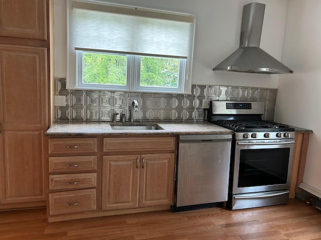 6 Felix Ct, Baldwin, NY 11510 - kitchen featuring stainless steel appliances, wall chimney exhaust hood, a sink, and decorative backsplash