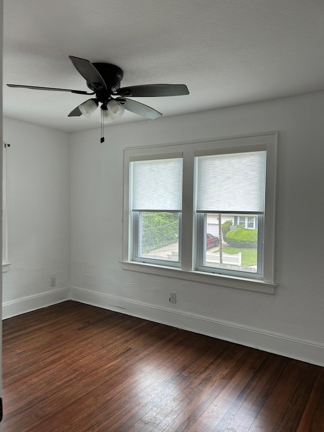 6 Felix Ct, Baldwin, NY 11510 - unfurnished room with dark wood-style floors, a ceiling fan, and baseboards