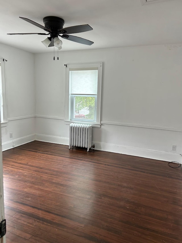 6 Felix Ct, Baldwin, NY 11510 - spare room featuring radiator, wood finished floors, a ceiling fan, and baseboards