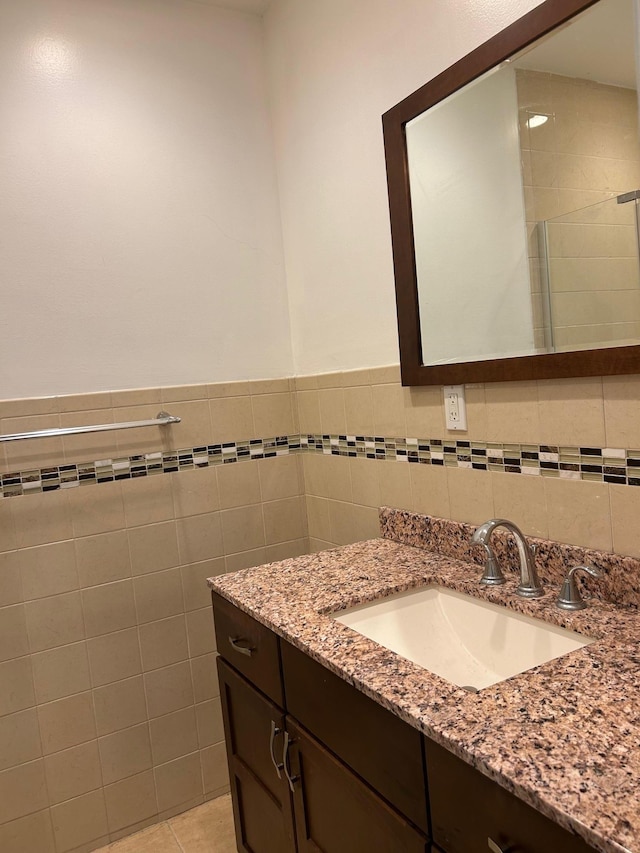 6 Felix Ct, Baldwin, NY 11510 - bathroom featuring vanity, tile walls, and a wainscoted wall
