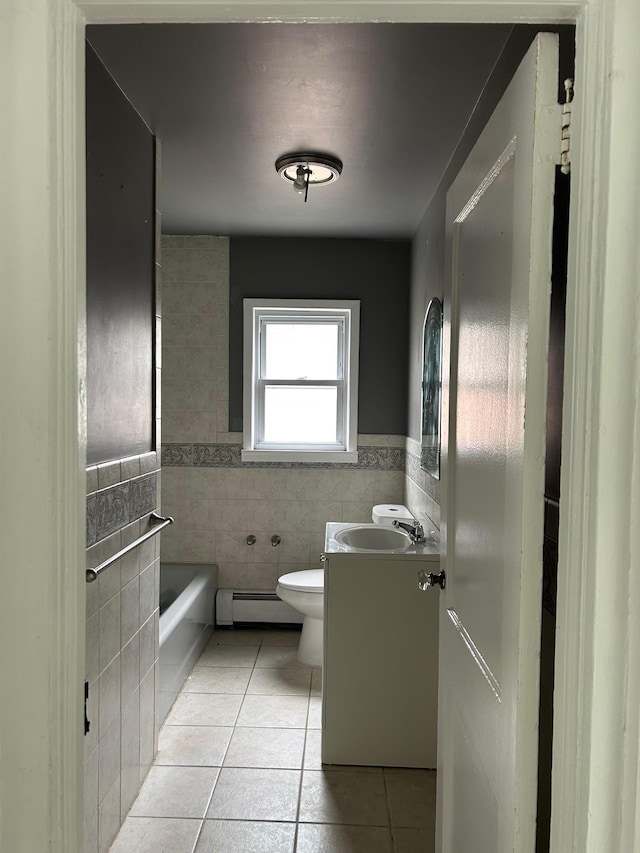 6 Felix Ct, Baldwin, NY 11510 - full bath with tile patterned flooring, tile walls, a baseboard heating unit, vanity, and a bath
