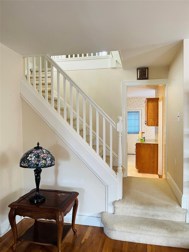 stairs with hardwood / wood-style floors