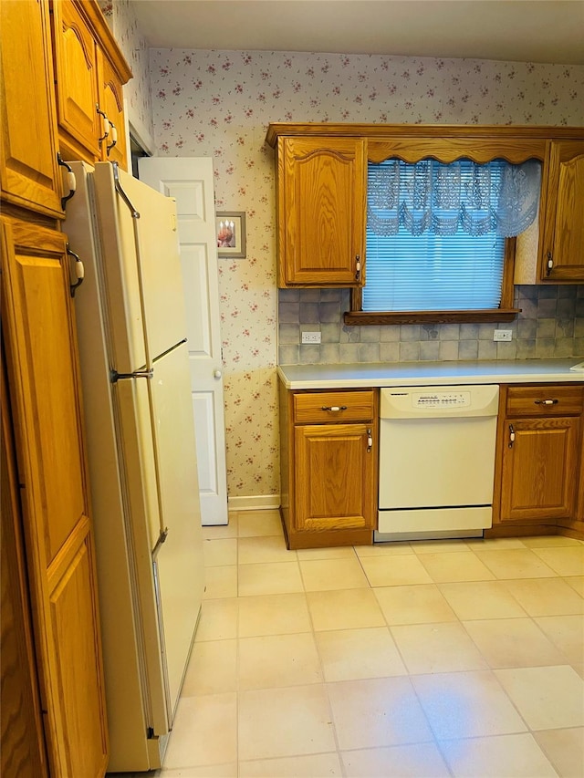 kitchen with light tile patterned flooring, decorative backsplash, and white appliances