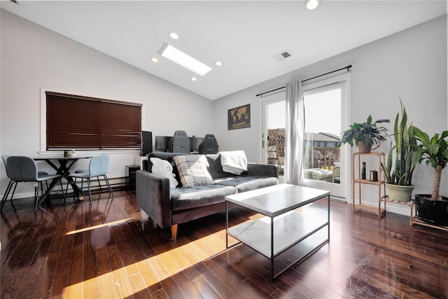 living room featuring vaulted ceiling with skylight and dark hardwood / wood-style flooring